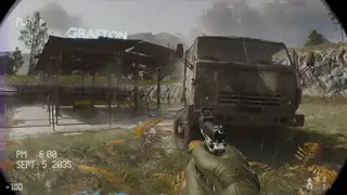 A rusted military truck beside a fenced checkpoint in Dead Fibers