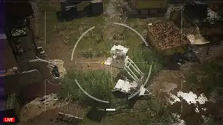 Overhead drone view of an infected figure near a lift tower in Dead Fibers
